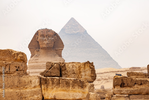 View of Statue of The Great Sphinx of Giza in The Giza Plateau and The Great Pyramid of Giza in the background.