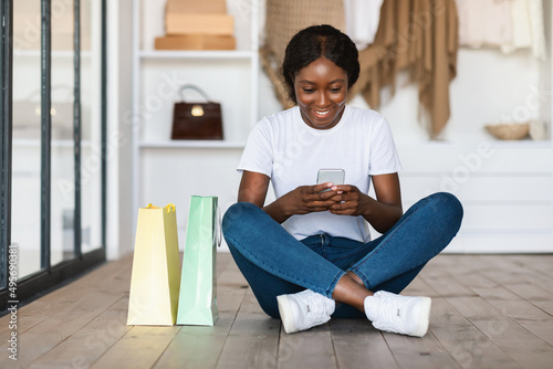 Happy Black Female Buyer Shopping Online Using Cellphone At Home © Prostock-studio