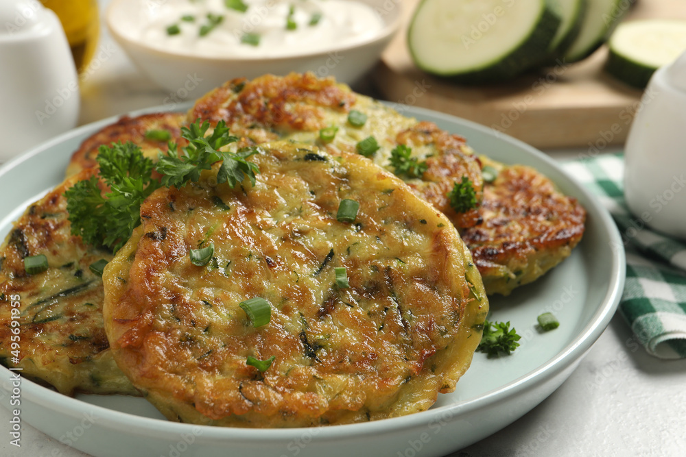 Delicious zucchini fritters served on table, closeup Delicious zucchini fritters served on table, closeup