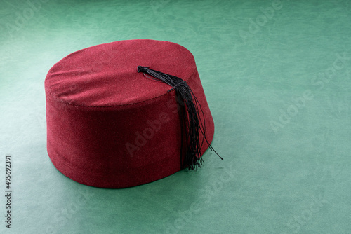 turk fez hat on green leather