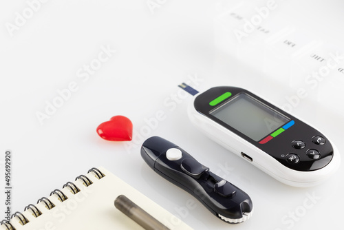 Glucose meter, lancets, pills and diary of control with pen