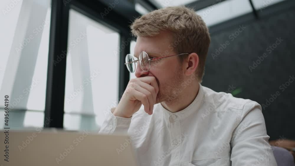 frustrated businessman or trader is sitting alone in office in front of laptop and thinking hard, portarit of smart entrepreneur frustrated businessman or trader is sitting alone in office in front of laptop and thinking hard, portarit of smart entrepreneur