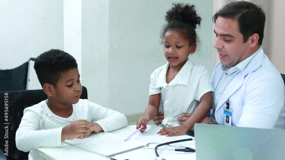 pediatrician talking to the boy and african girl in clinic pediatrician talking to the boy and african girl in clinic