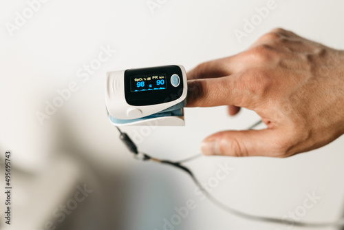 Pulsometer. Device for measuring heart rate, heart rate, oximeter. Technological device on the finger. Portable, soft, small meter for health. Coronavirus, pandemic, quarantine covid-19. High oxygen