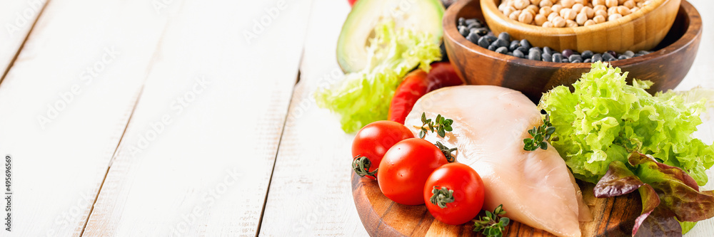 Raw chicken and fresh vegetables on a table. Healthy food. Selective focus. Copy space Raw chicken and fresh vegetables on a table. Healthy food. Selective focus. Copy space