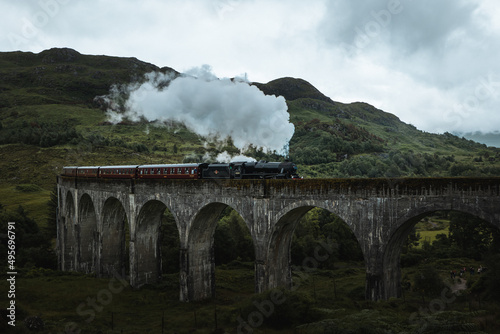 Famous Glenfinnan Railway Viaduct in Scotland with the Jacobite steam train passing over photo