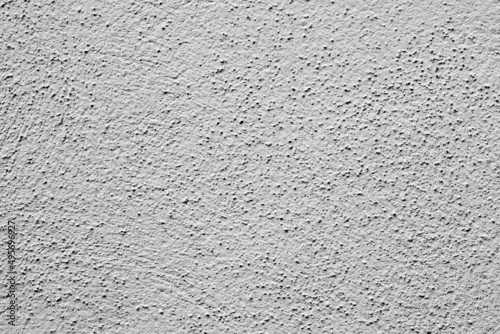 Painted wall with rough texture closeup. Grey plaster with brushed texture, house wall, copy space