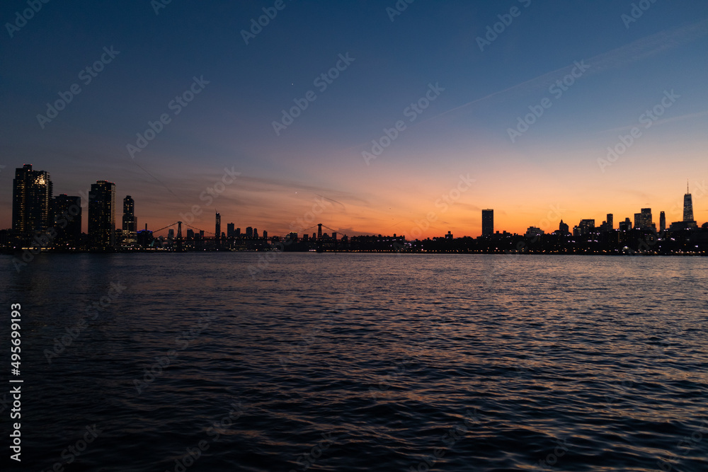 Colorful Sunset along the East River in New York City with the Williamsburg Bridge