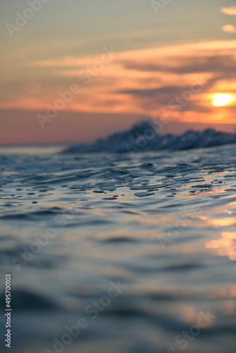 Close-up of the sea surface against the sunset.