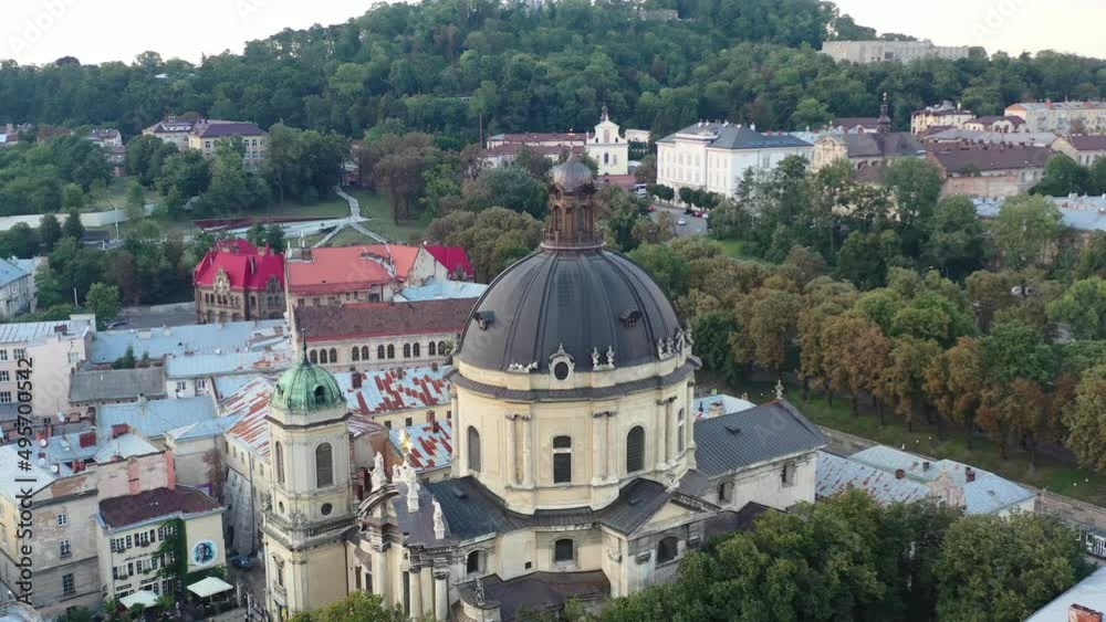 Drone flying over the dome of a cathedral in Lviv Ukraine during sunset surrounded by European buildings Drone flying over the dome of a cathedral in Lviv Ukraine during sunset surrounded by European buildings