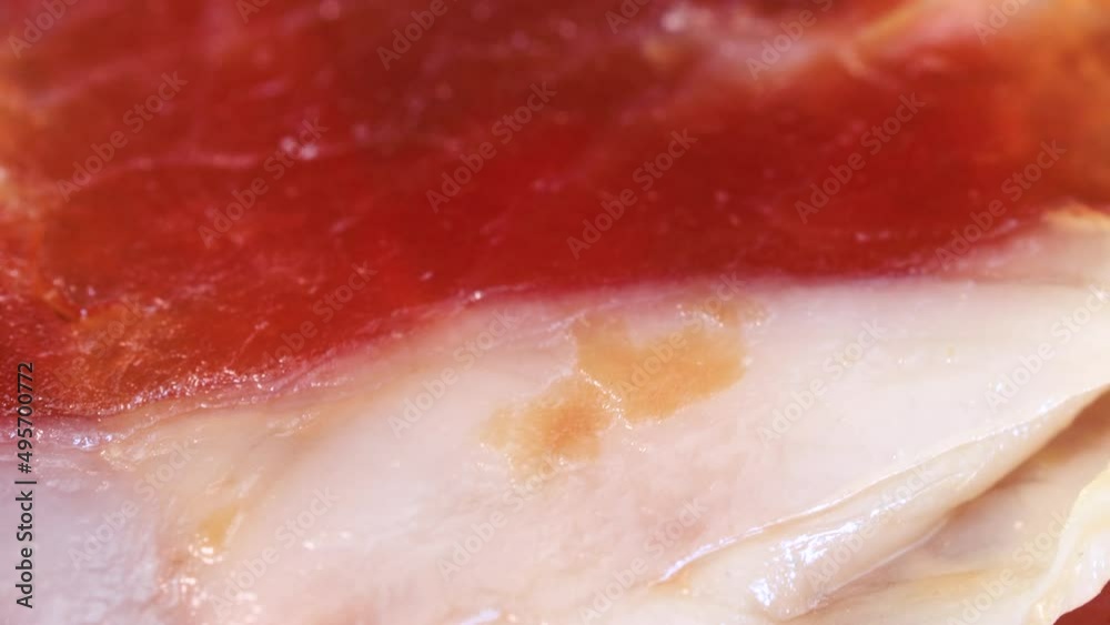 Air dried ham slices rotating, macro shot. Air dried ham slices rotating, macro shot.