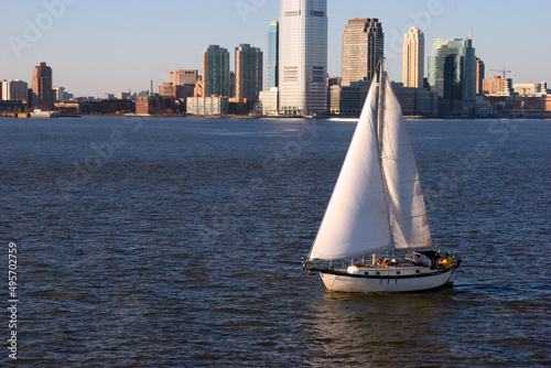 Fotografie, Obraz Boat in the Hudson River and buildings of New York City in the USA during daytim