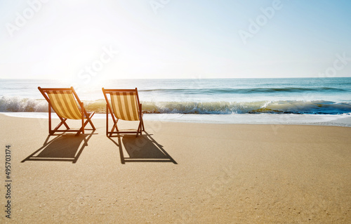 Fototapeta Naklejka Na Ścianę i Meble -  Two chairs on the beach.