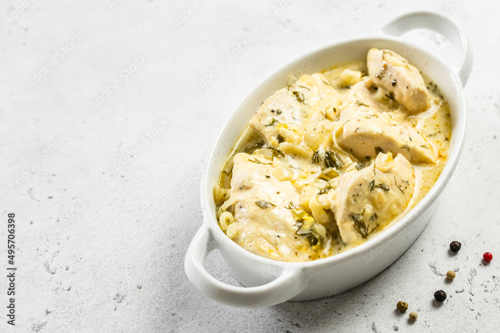 Creamy lemon pepper chicken fillet creamy sauce in ceramic dish. Space for text. Creamy lemon pepper chicken fillet creamy sauce in ceramic dish. Space for text.