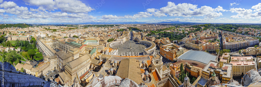  Famous Saint Peter's Square in Vatican and aerial view of the Rome city during sunny day.