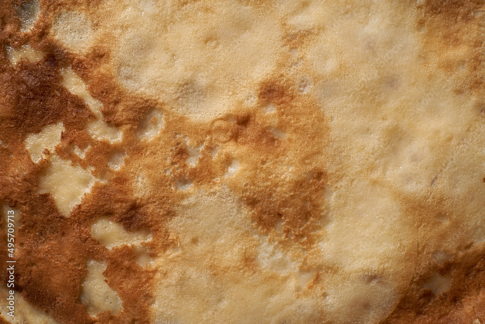 Texture of a cooked thin pancake closeup. Fried pancakes. Texture of a cooked thin pancake closeup. Fried pancakes.