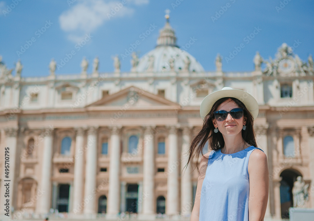 Fototapeta premium Happy young woman in Vatican city and St. Peter's Basilica church, Rome, Italy.