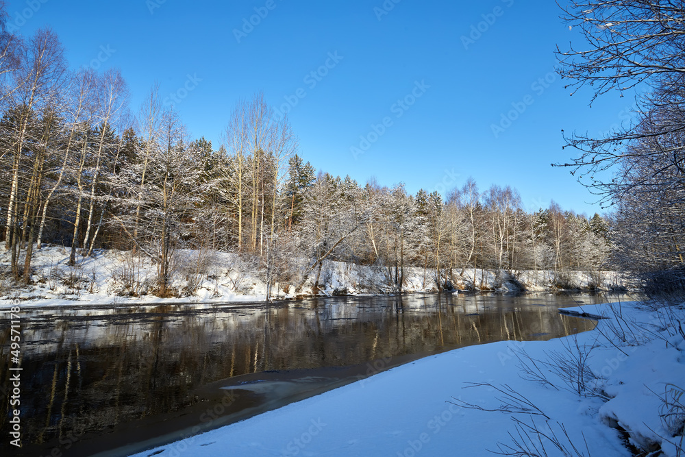 Ice drift on the river on a spring day in the forest near birch trees. Concept of spring floods. Ice drift on the river on a spring day in the forest near birch trees. Concept of spring floods.