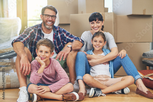 Home - a place of love and happiness. Portrait of a happy family spending time together in their home on moving day.