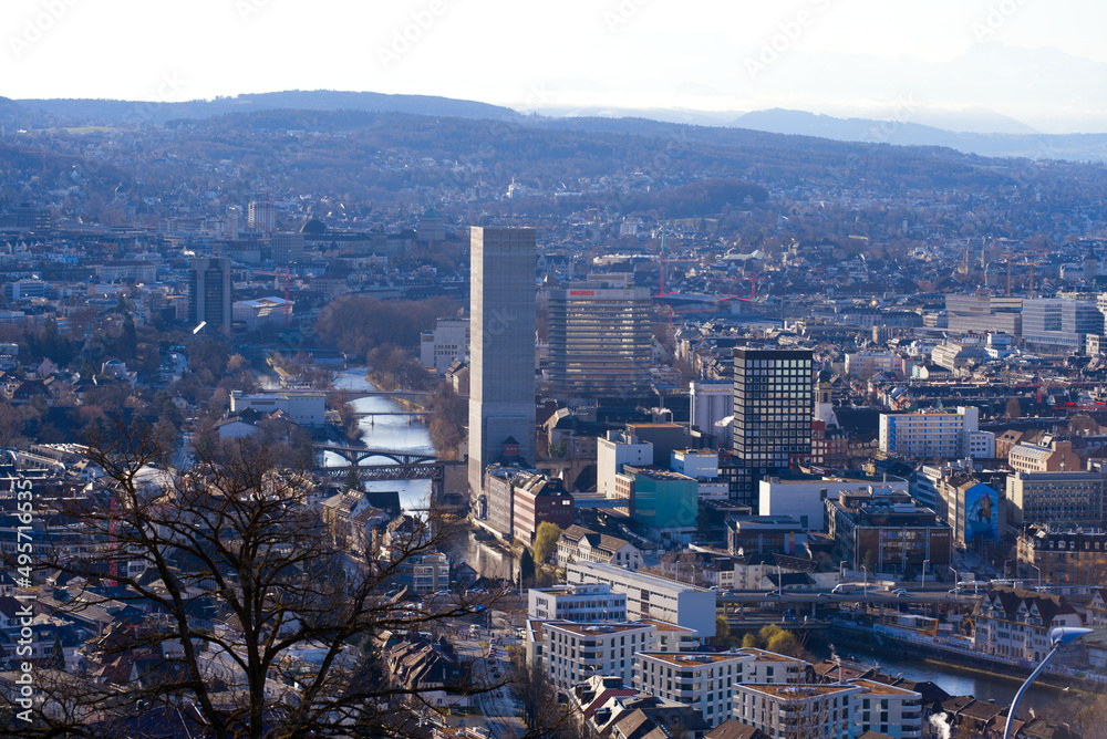 Aerial view over City of Zürich with grain silo tower and river Limmat and mountains in the background on a blue and cloudy spring morning. Photo taken March 14th, 2022, Zurich, Switzerland.