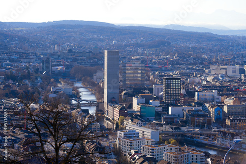 Aerial view over City of Zürich with grain silo tower and river Limmat and mountains in the background on a blue and cloudy spring morning. Photo taken March 14th, 2022, Zurich, Switzerland.