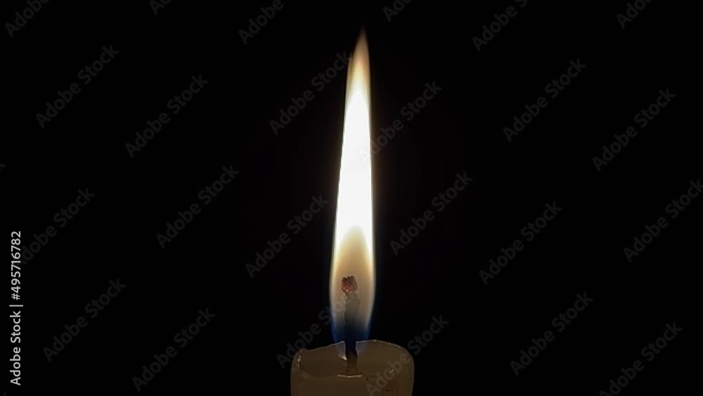 Burning candle on a dark background.Romantic evening. High quality 4k footage Burning candle on a dark background.Romantic evening. High quality 4k footage