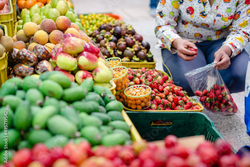 woman buying vegetables in paloquemado market square Bogota Colombia