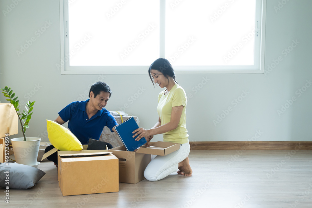 Asian couple lover unpacking thing after relocation to new apartment. Asian couple lover unpacking thing after relocation to new apartment.