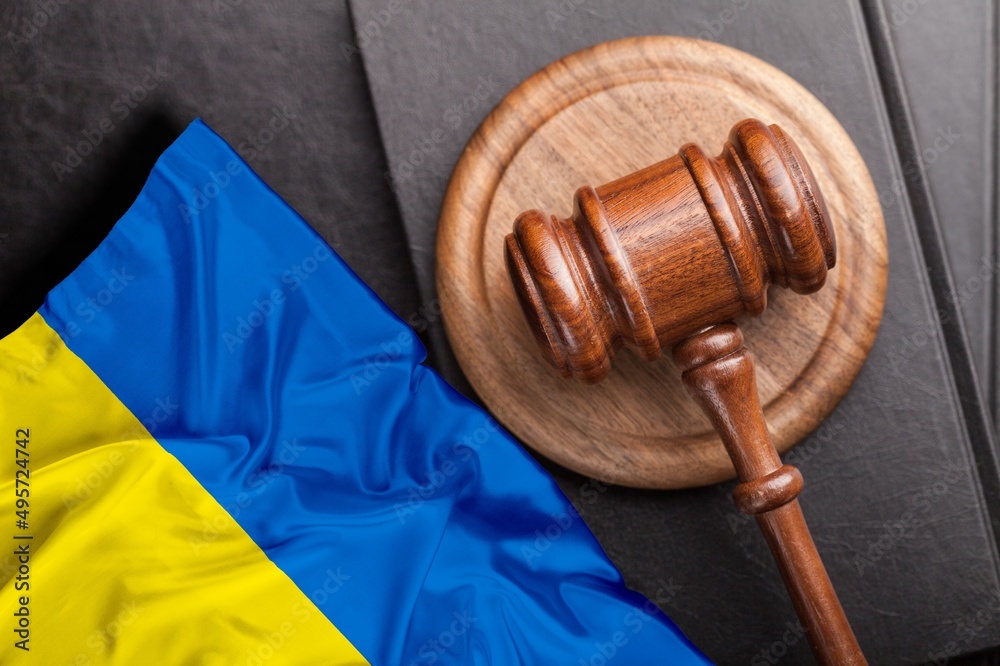 Judge's law gavel with flag of Ukraine on desk