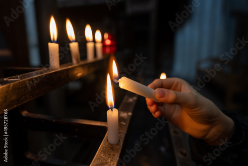 lighting a candle in a church