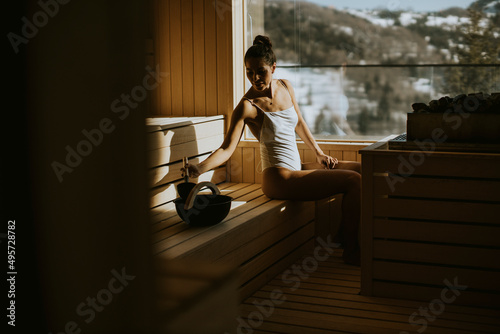 Young woman pouring water o...