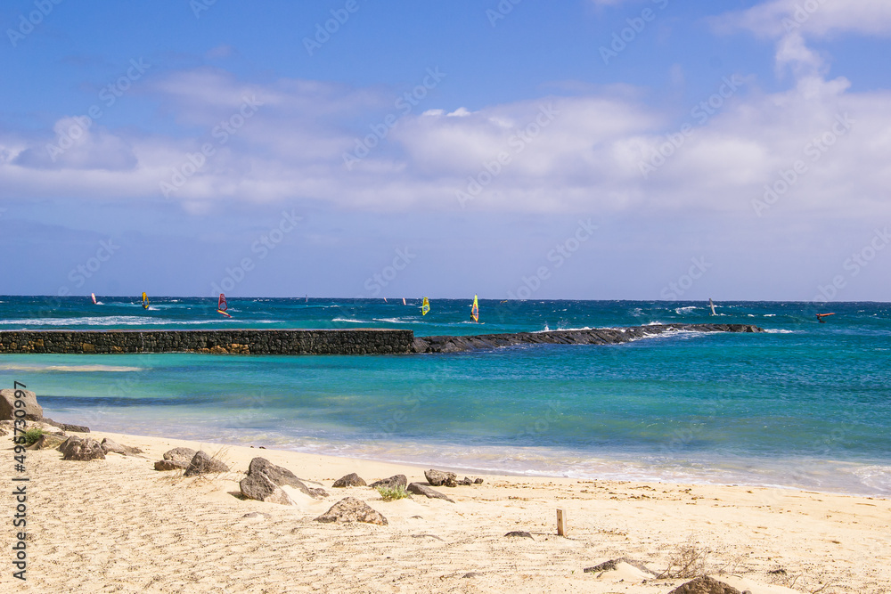 Looking out to sea from Baja de los Charcos, Costa Teguise, Lanzarote at a number of Windsurfers