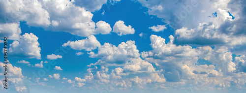 Beautiful background with picturesque white fluffy clouds in blue sky © haidamac