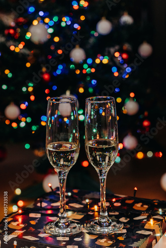 Two glasses of champagne on the background of festive Christmas lights. Glass for wine. bokeh. Christmas. New Year
