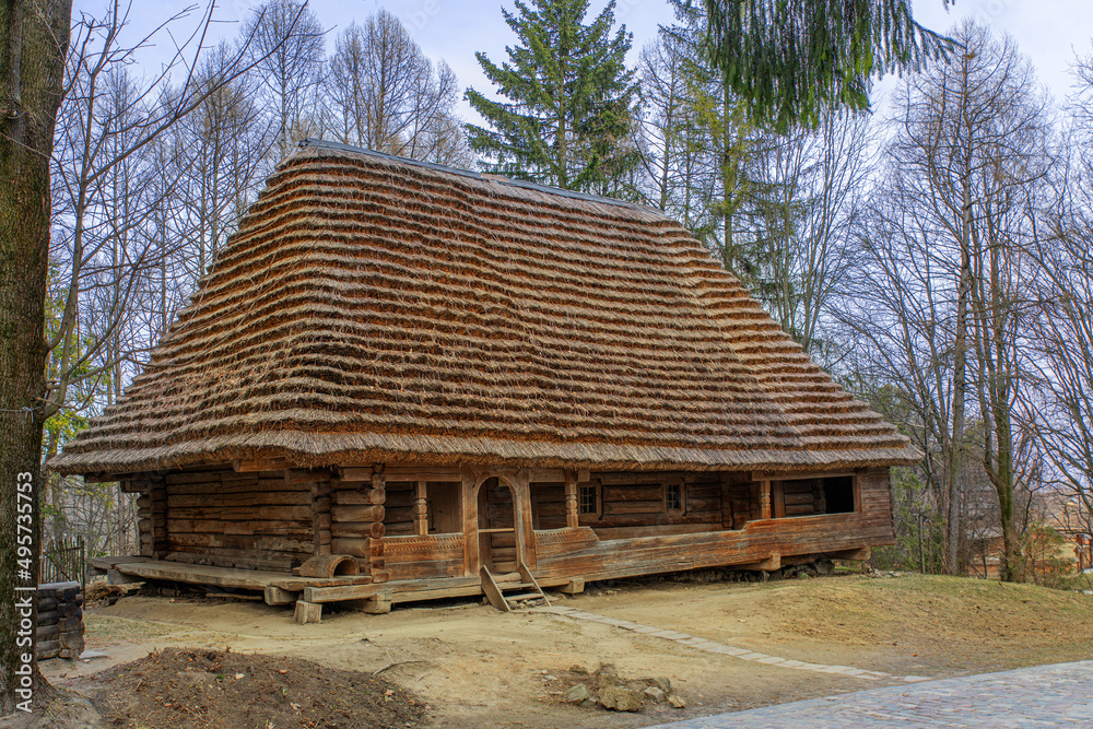 Old traditional wooden house in the village on a sunny spring day. Old traditional wooden house in the village on a sunny spring day.