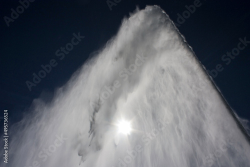 jet de eau of geneva jet of water and the sun can be seen from behind.