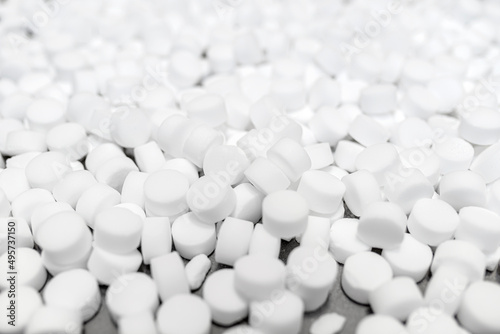 Background made of salt tablets for a water softener, large round cubes. photo