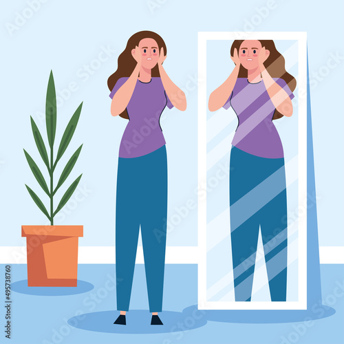 sad woman looking fat in mirror
