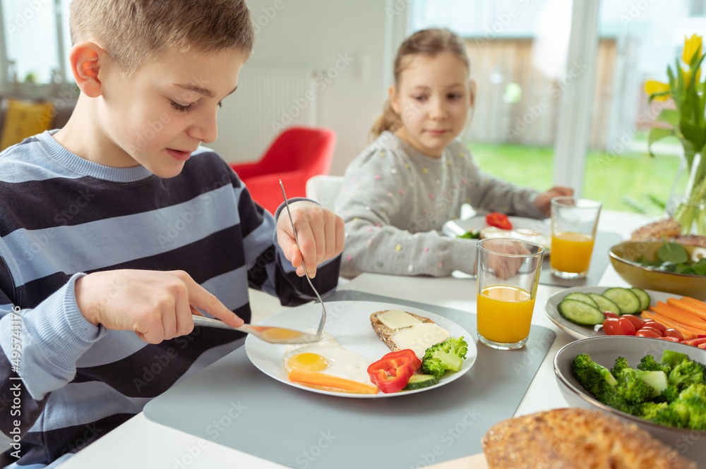 Teen brother and sister eating healthy breakfast at home Teen brother and sister eating healthy breakfast at home