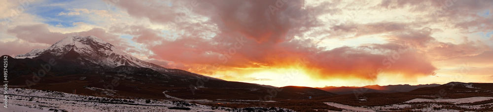 Panoramic view of the snowy Chimborazo volcano and its surroundings in a cloudy sunset
