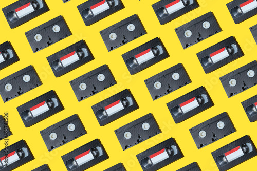 Canvas-taulu VHS video cassette, Old black videotape pattern on a yellow background, Outdated technology background