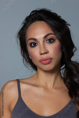 Beautiful brunet model woman face with brown eyes and perfect make-up . Portrait of beauty young brunet girl with pink lips. Female face with clear skin close-up. Skincare