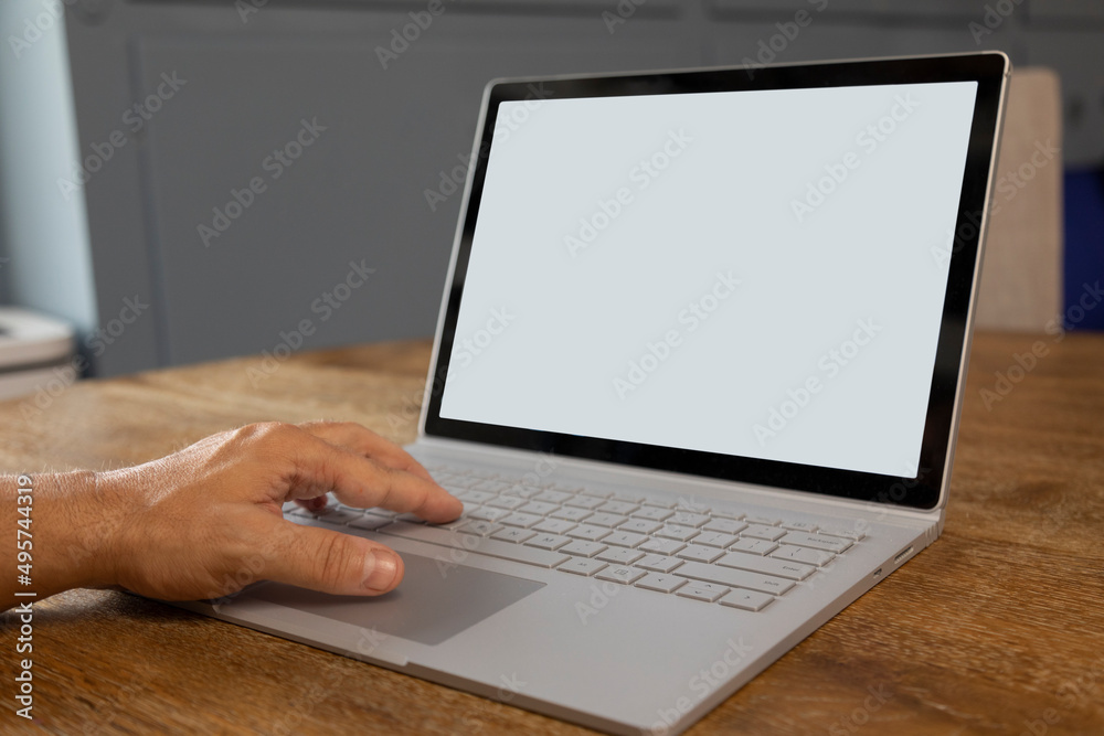 Man using a laptop computer in a home office Man using a laptop computer in a home office