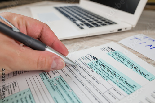 Close-up female hands with tax form 1040.