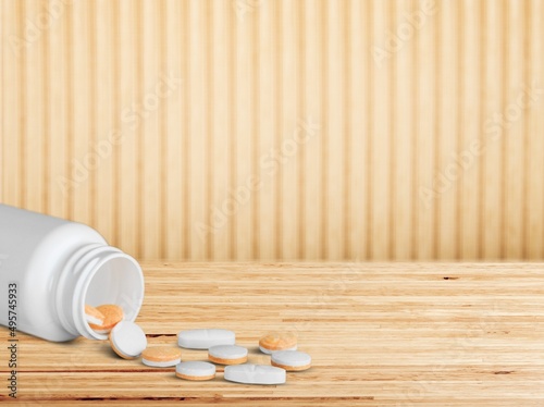 Tablets for radiation protection on the wooden table with a plastic medical jar photo