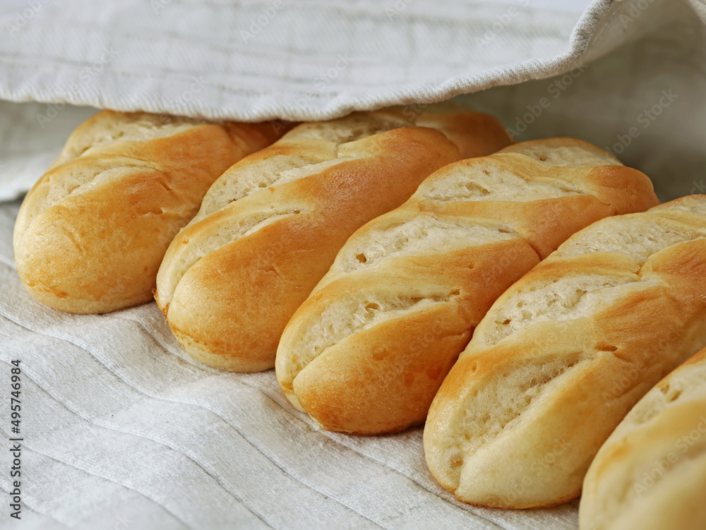 french milk bread buns on gray kitchen towel, close up of delicious french food