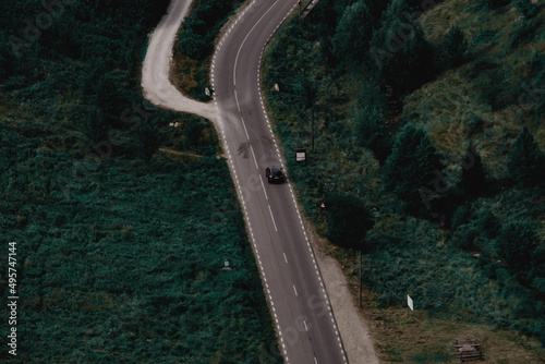 Aerial view of a car driving on the road in the area of Cheile Valisoarei, Romania photo