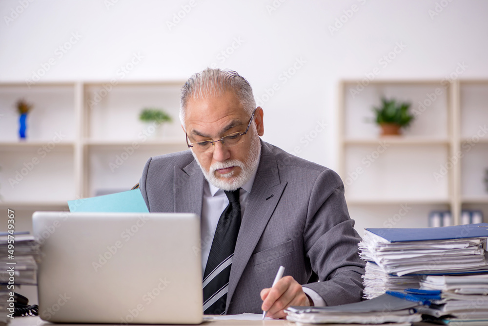 Old male employee and too much work in the office Old male employee and too much work in the office