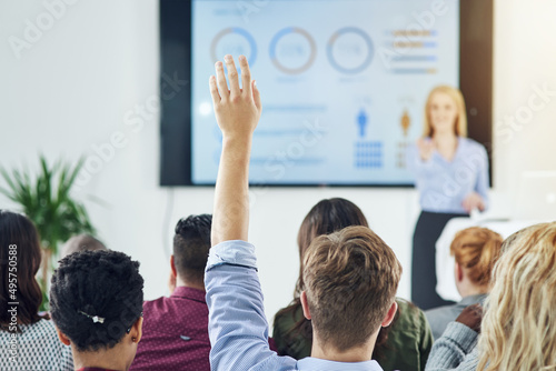Raise your hands for learning opportunites. Shot of a group of businesspeople raising their hands in a class.