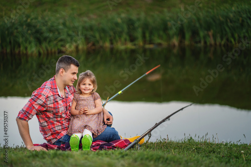Dad and child fishing at lake
